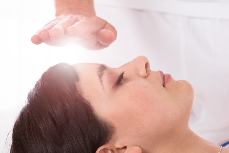 Close-up,Of,A,Relaxed,Young,Woman,Having,Reiki,Healing,Treatment